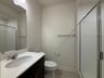secondary bathroom with a walk-in shower