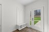 mudroom area with a bench, cubbies and hooks