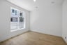 study with wood floor, white walls, large window, and recessed ceiling light