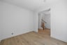 study with wood floors, white walls, and view of front entry foyer