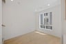 dining room with wood floors, white walls, and large window