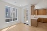 dining room with wood floors, large window, and french door leading to balcony