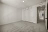bedroom with gray carpet, white walls, closet, and recessed ceiling light