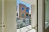 balcony with glass enclosure and view of buildings