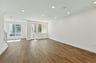 great room with wood floors, white walls, recessed ceiling lights, and multiple windows
