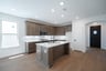 open kitchen with wood floors and island