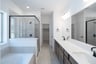 primary bathroom with soaking tub and walk-in shower