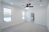 primary bedroom with carpet and ceiling fan