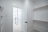 primary bedroom closet with carpet and white shelves