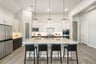 kitchen with pendant lights and 4 barstools