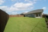 backyard with grass and covered patio