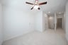 open gameroom with carpet and ceiling fan
