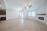 open great room with wood floors and fireplace