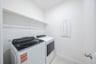 laundry room with tile floors, washer, and dryer