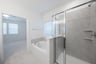 primary bathroom with soaking tub and walk-in shower
