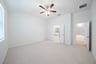 primary bedroom with carpet and ceiling fan