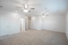 open gameroom with carpet and ceiling fan