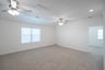 open gameroom with carpet and ceiling fan