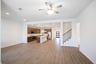open great room with wood floors and ceiling fan