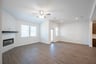 open great room with wood floors and fireplace