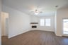 open great room with wood floors and ceiling fan