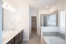 primary bathroom with soaking tub and walk-in shower