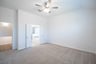 primary bedroom with carpet and ceiling fan