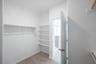 primary bedroom closet with carpet and white shelves
