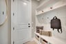 mudroom with a bench with hooks and cubbies
