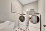 laundry with a wire shelf and a sink