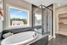 primary bath with separate tub and shower