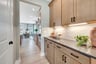 butler's pantry connecting the kitchen and the dining room
