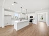 kitchen with white cabinets, quartz countertops, and pendant lighting