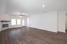 open great room with wood floors and fireplace