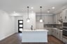open kitchen with wood floors and island