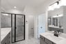 primary bathroom with walk-in shower and tile floors
