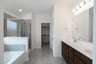 primary bathroom with soaking tub and shower