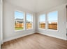 dining room with brown flooring and windows 