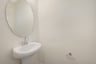 powder room with an oval mirror