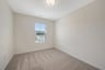 secondary bedroom with a window