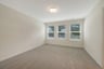 primary bedroom with three windows