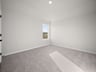 bedroom with carpet, a window & a sloped ceiling
