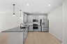 kitchen with quartz countertops and gray cabinets