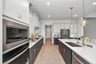 rendered kitchen photo with wood-look tile flooring