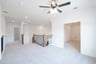 open gameroom with carpet and ceiling fan