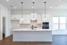 open kitchen with wood floors and island