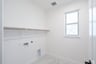 laundry room with tile floors and white shelf