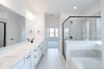 primary bathroom with soaking tub and walk-in shower