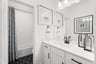bathroom with white cabinets and countertops 
