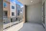 outdoor balcony with glass enclosure and view of building